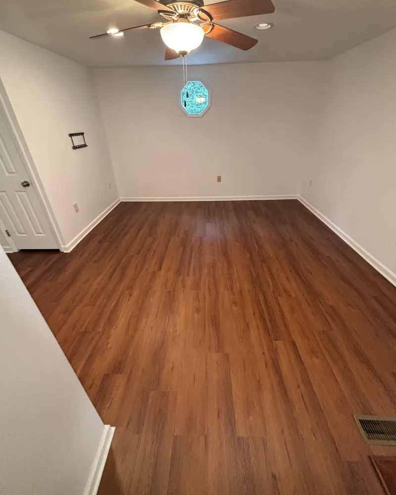 Same bonus room with new warm-toned LVP flooring