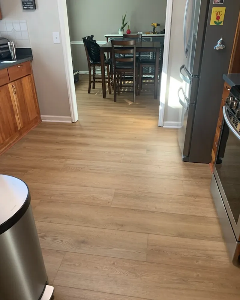 Same kitchen and dining room with continuous new LVP flooring
